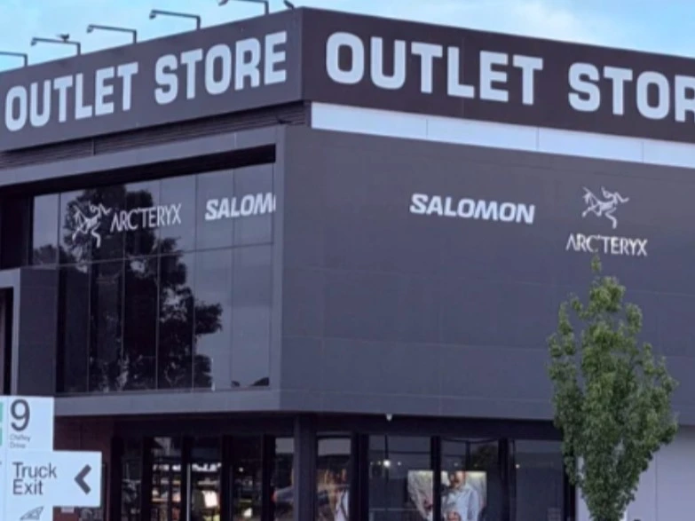 Shoppers browsing outdoor jackets and footwear in a Melbourne outlet shopping centre