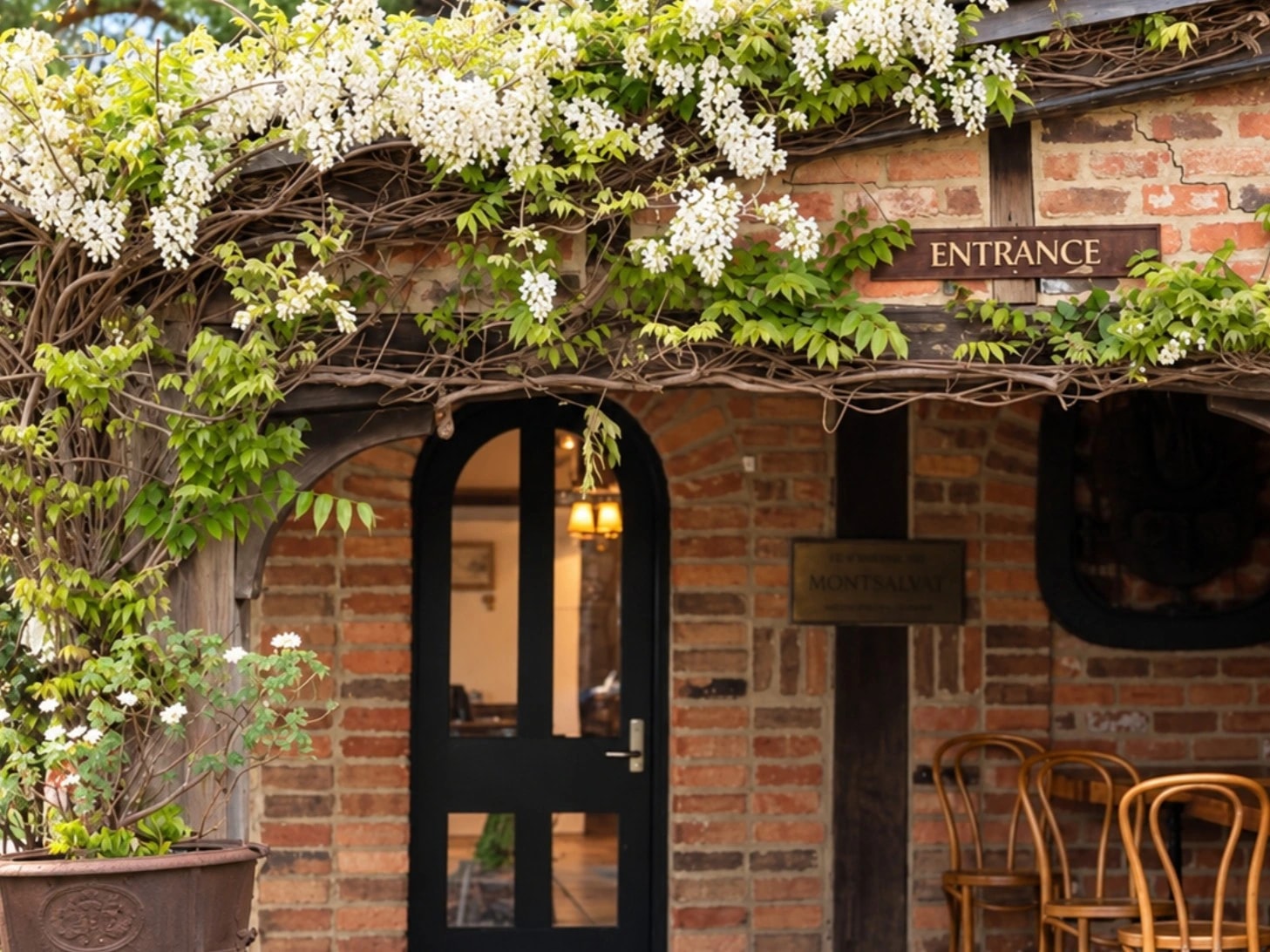 Stone and mudbrick buildings among leafy garden paths at Montsalvat in Eltham