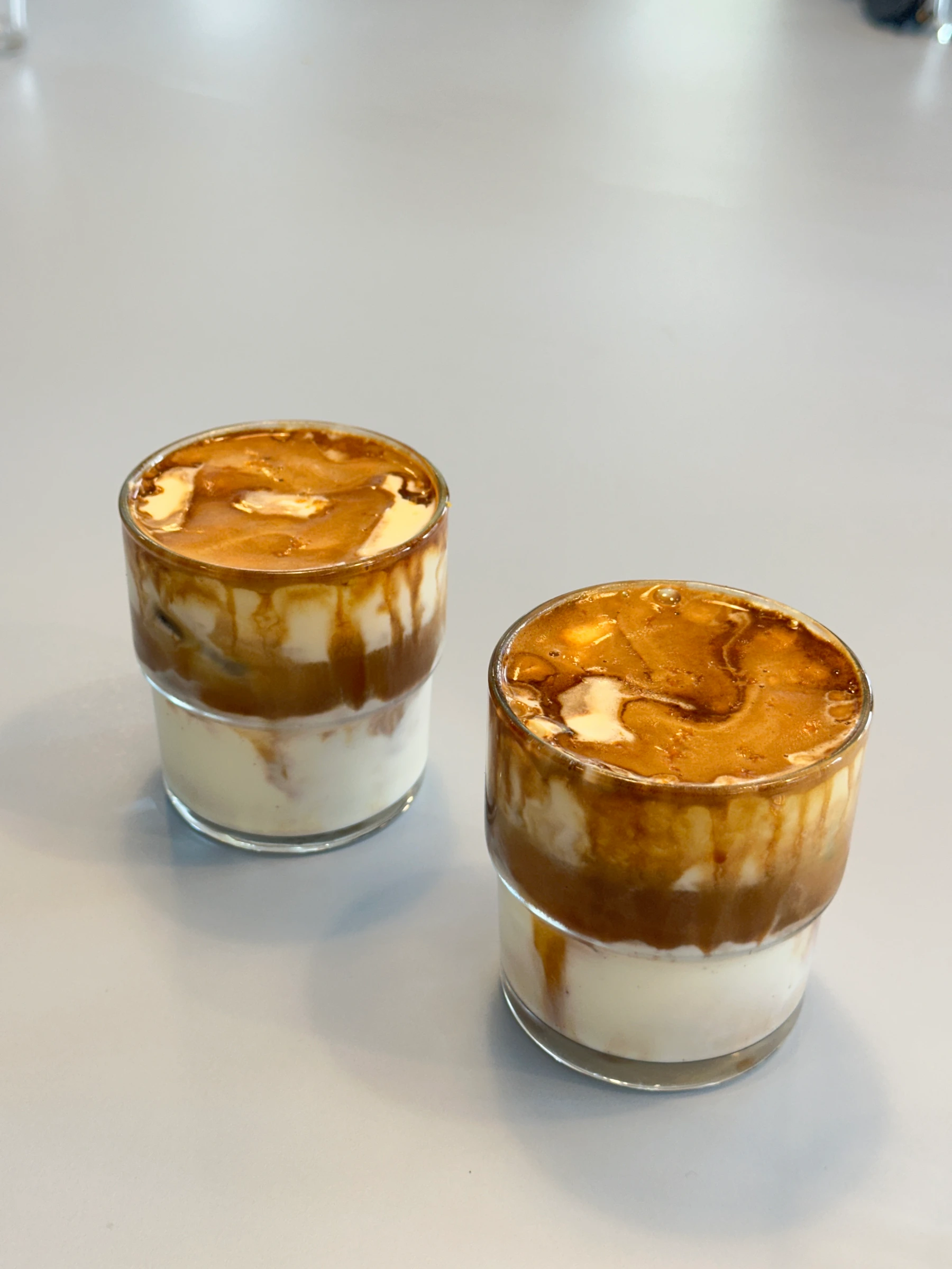 Coffee and espresso drinks on a café table at Tone Coffee in Melbourne