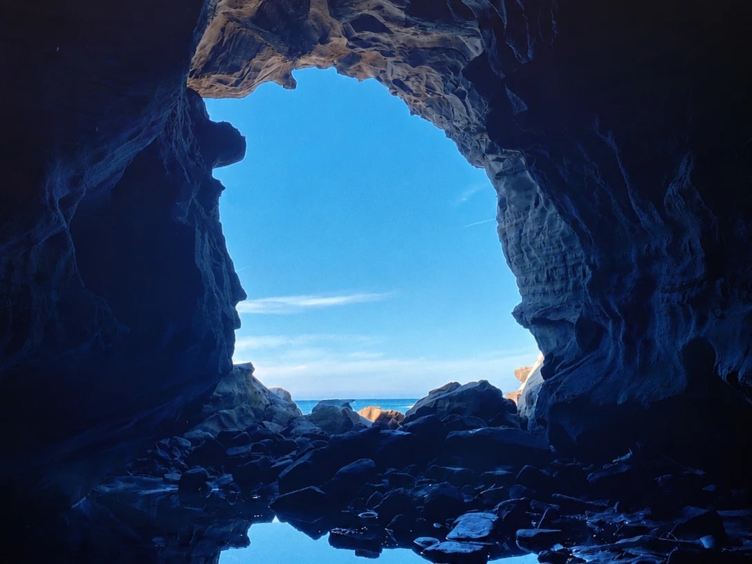 Layered coastal rock formations and the rocky shore at The Caves near Inverloch