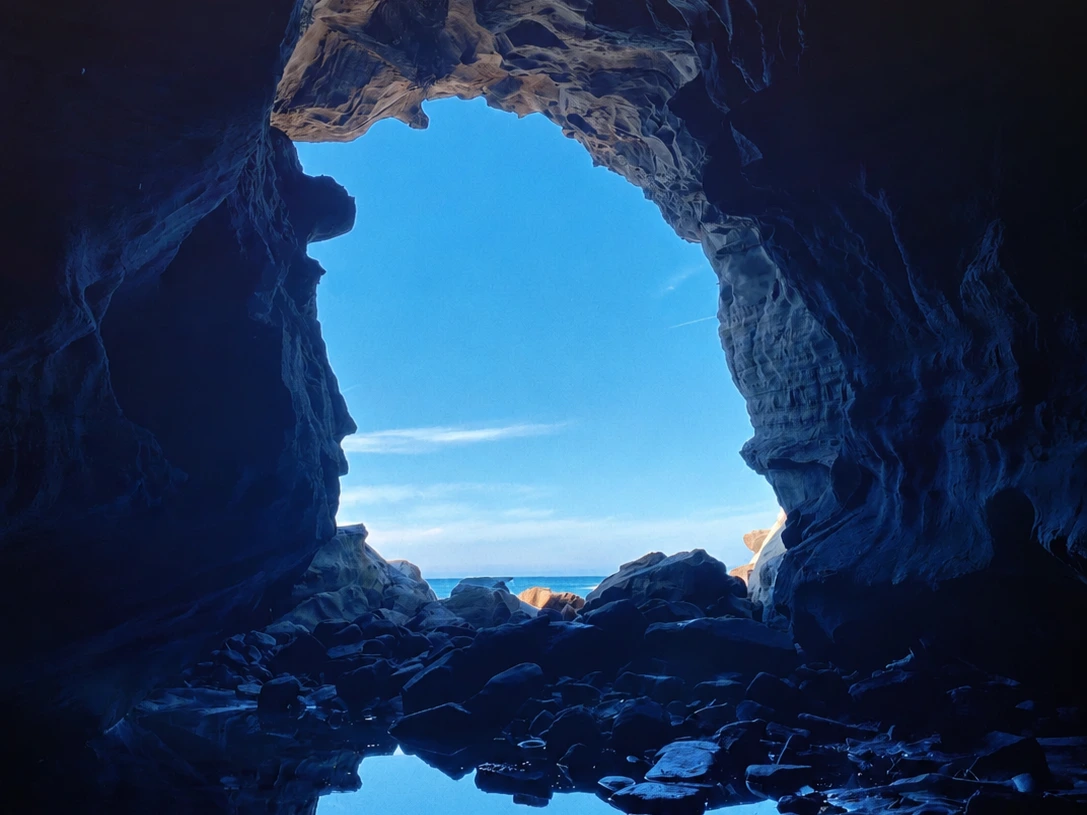 Layered coastal rock formations and the rocky shore at The Caves near Inverloch